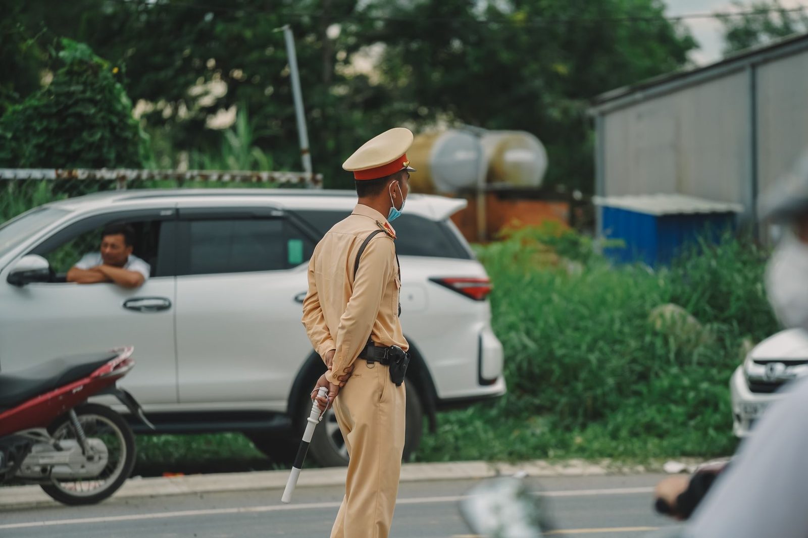 Agente de tránsito dirigiendo vehículos en una calle urbana.