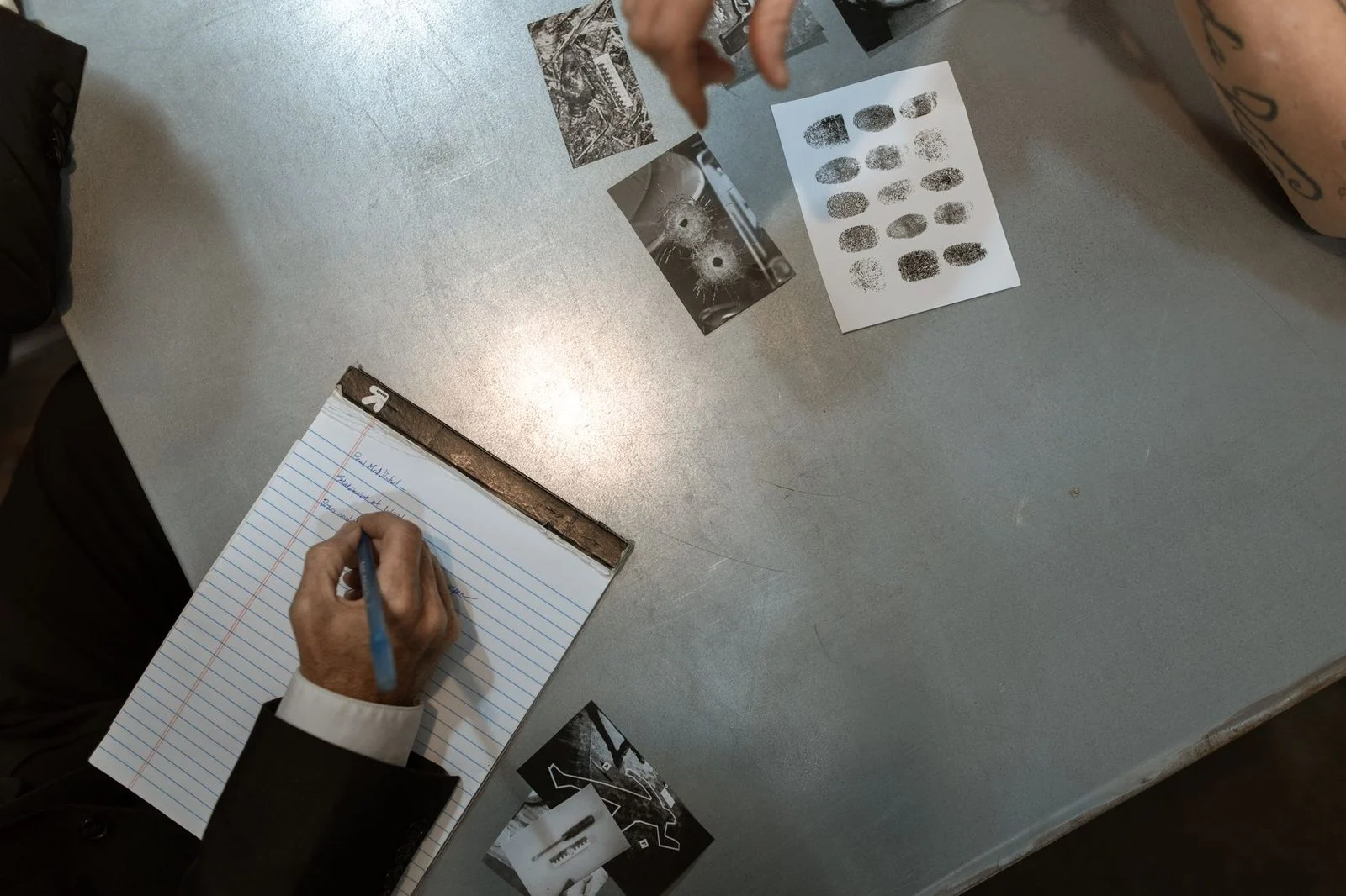 Police officers reviewing evidence and taking notes during an investigation.