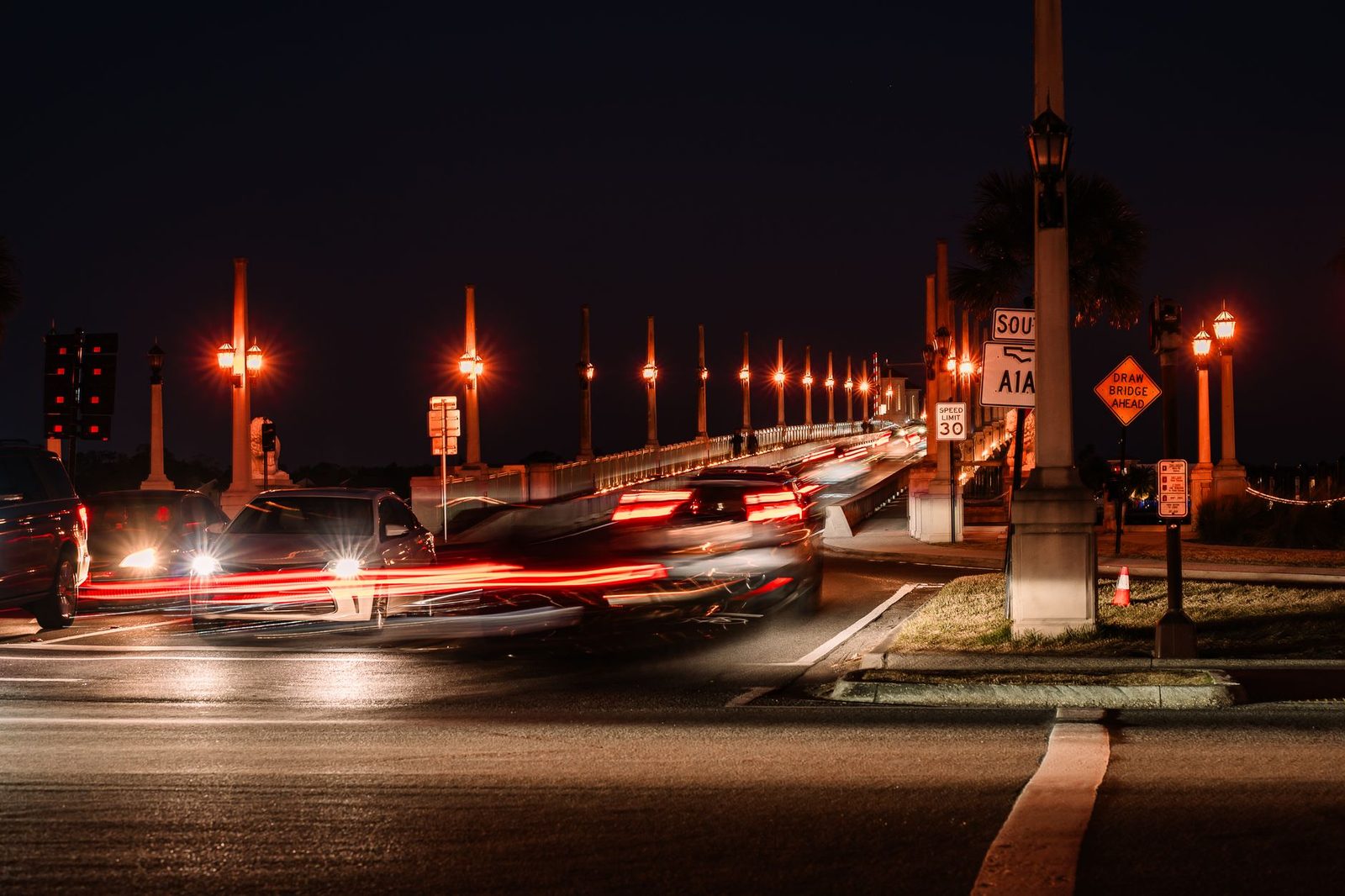 Traffic crossing a lit bridge at night in St. Augustine, Florida.